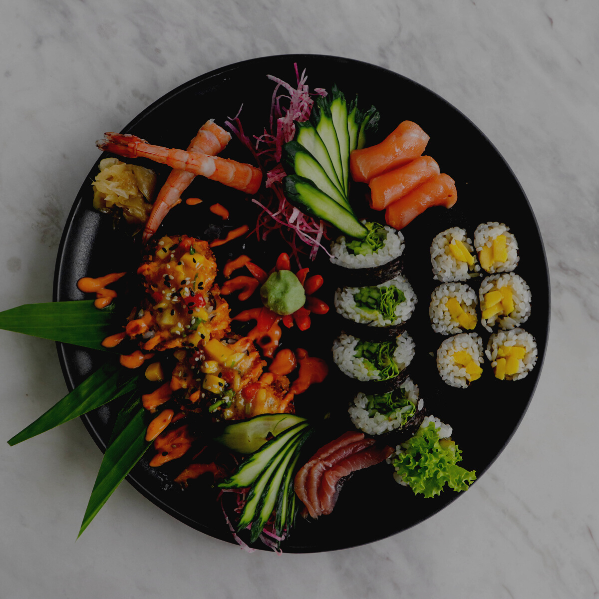 Sushi and Sashimi on a Black Plate